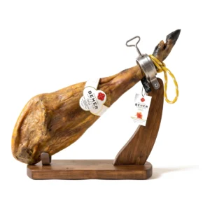Beher Oro Ibérico de bellota ham, whole and bone-in, on a wooden ham stand