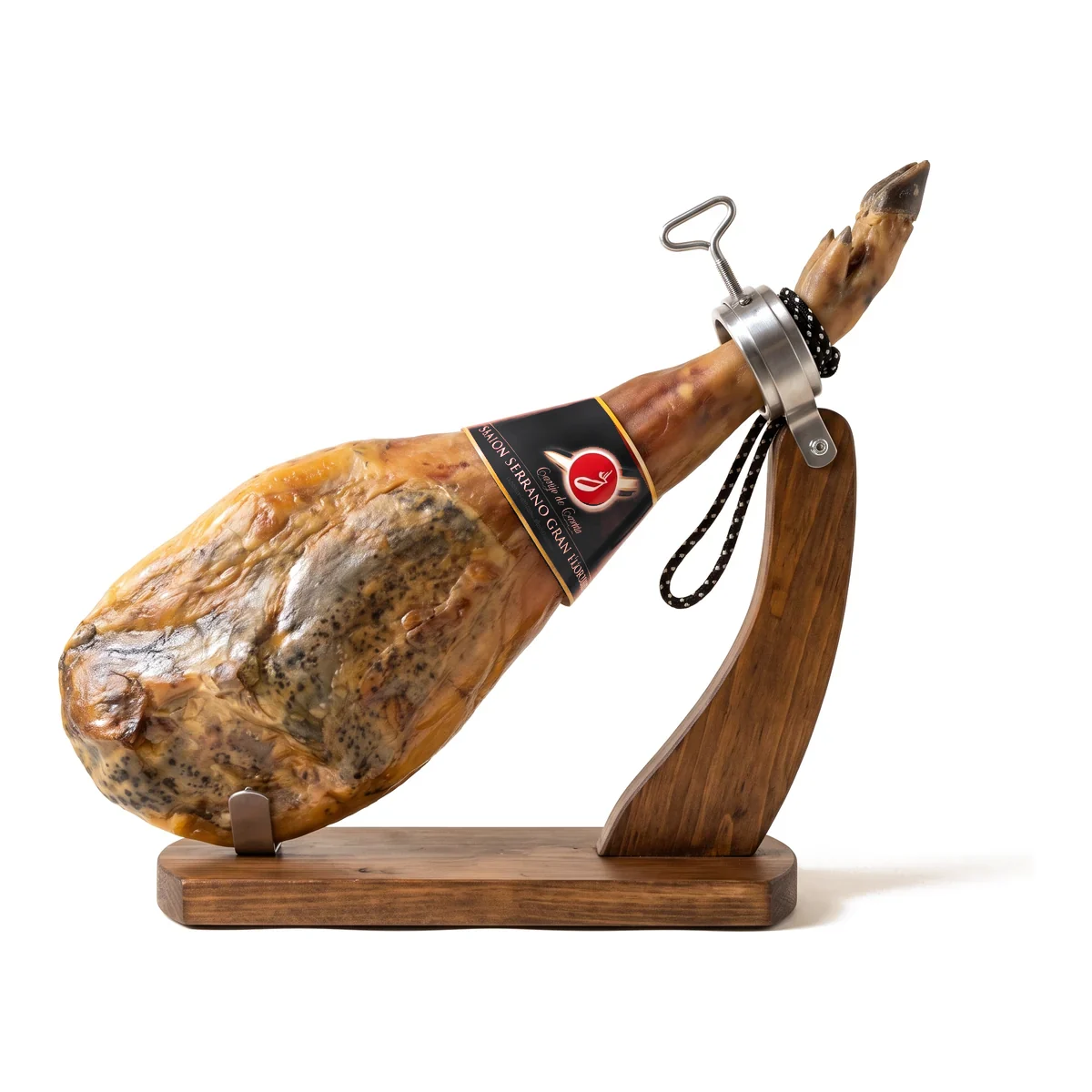 Cortijo de Canata Serrano Ham, Aged 15 Months, Whole Bone-In 15–17 lb Cortijo de Canata Serrano ham aged 15 months, whole and bone-in, with its black brand label, on a wooden ham stand