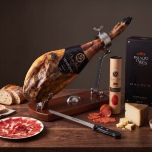Cinco Jotas Ibérico de Bellota ham on a folding ham stand with 5J lomo, olive oil gift case, Manchego and anchovy-stuffed olives